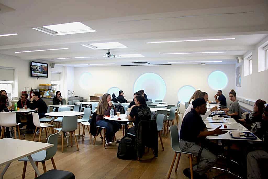 Students sitting at tables in the common room at Stafford House London