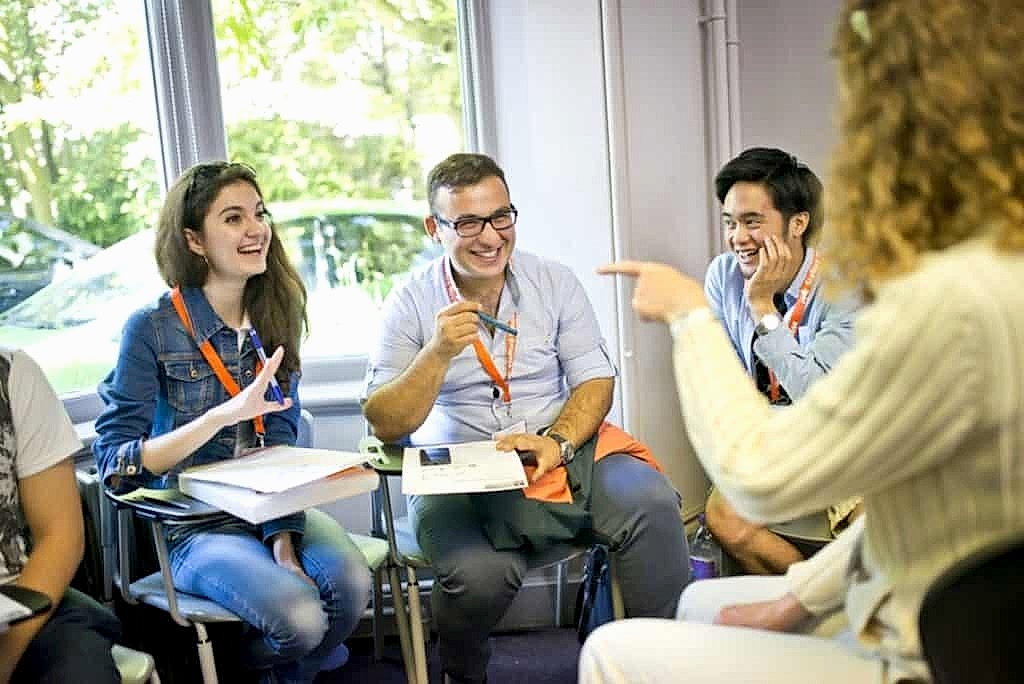 Teacher and students talking during a relaxed lesson at Stafford House Canterbury