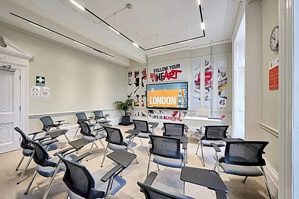 Classroom with rows of chairs and a large screen showing London at ES London