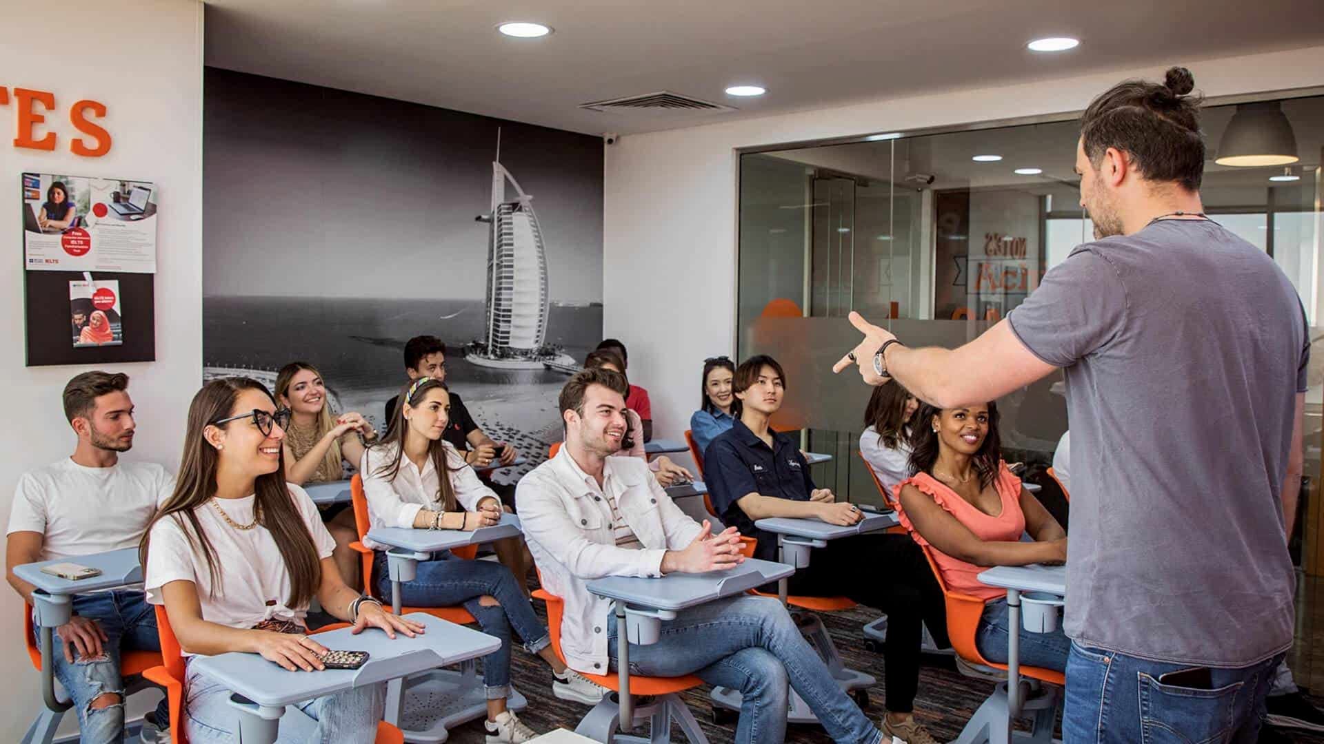 Teacher leading a lesson for students at desks in an ES London classroom