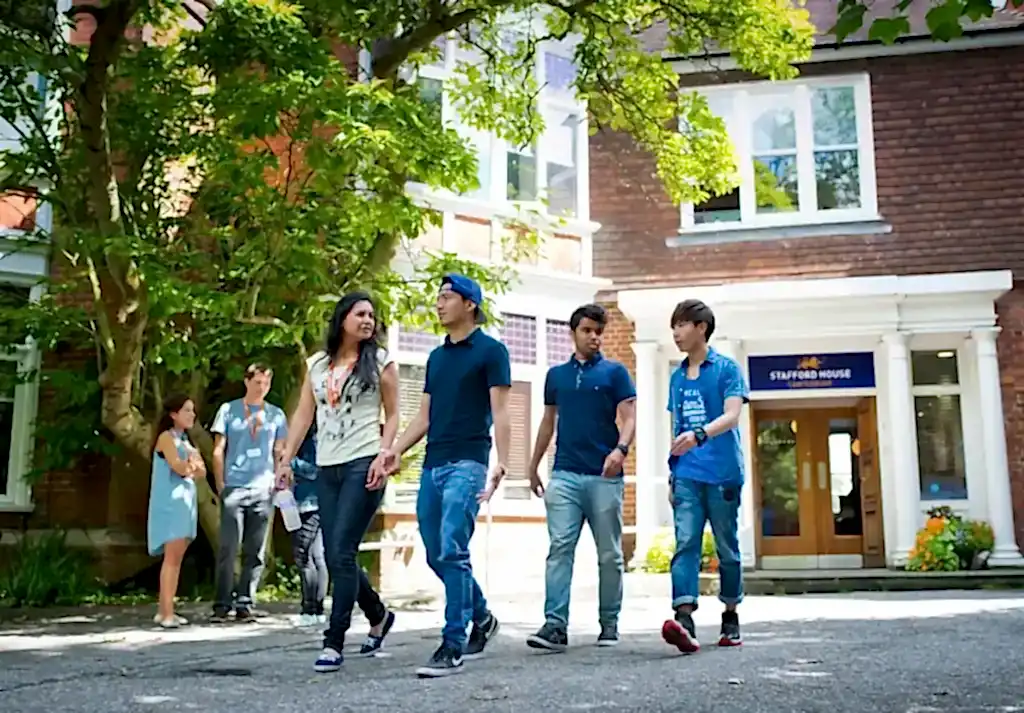 Students walking past the entrance of Stafford House Canterbury