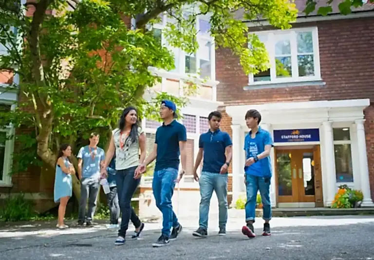 Students walking past the entrance of Stafford House Canterbury