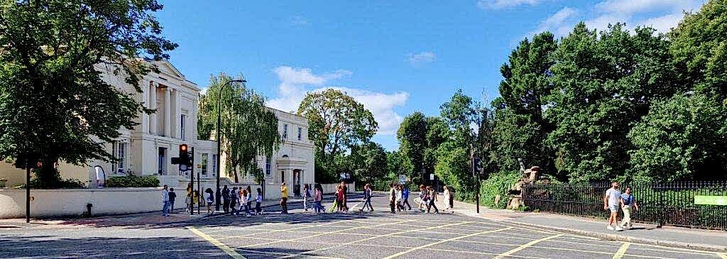 Group of children walking along a tree-lined London road near Gloucester Gate