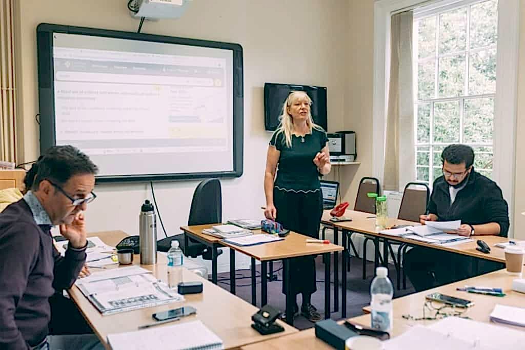 Teacher leading an adult class with an interactive whiteboard at ILC Colchester