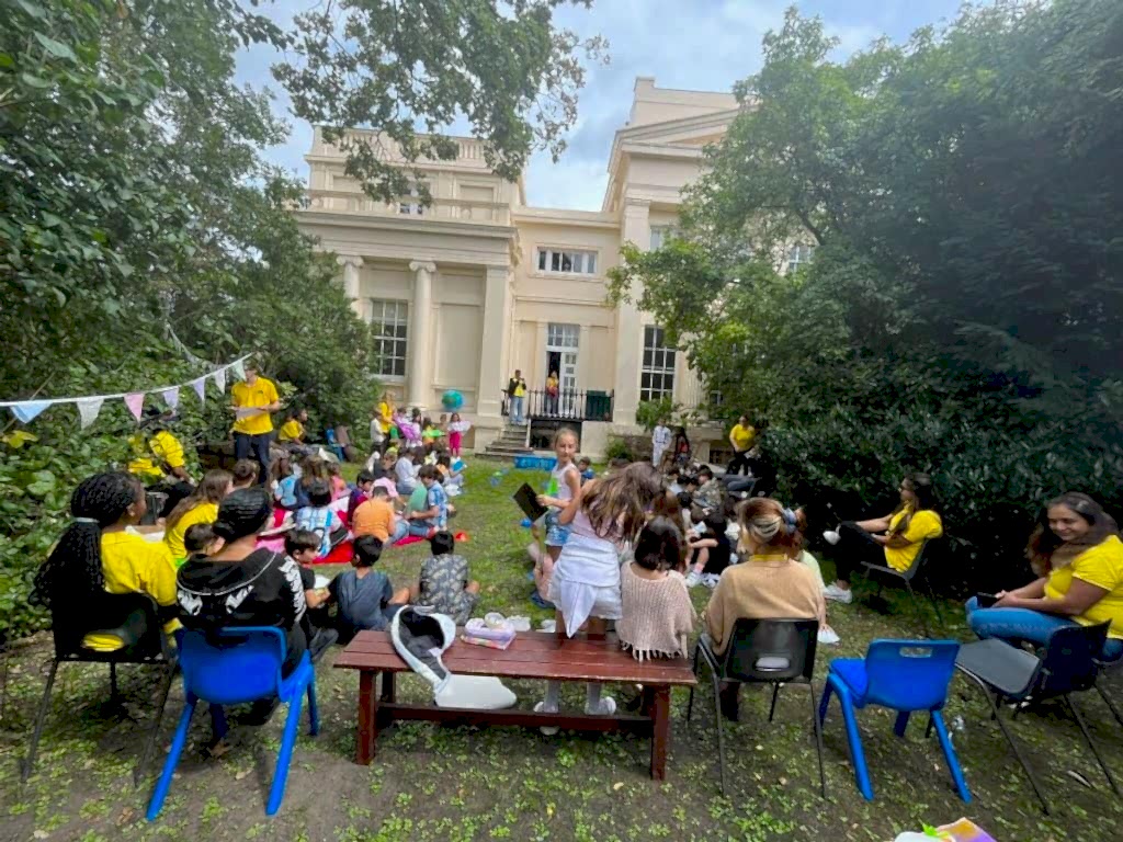 Children and staff gathered for an outdoor event in the Gloucester Gate garden