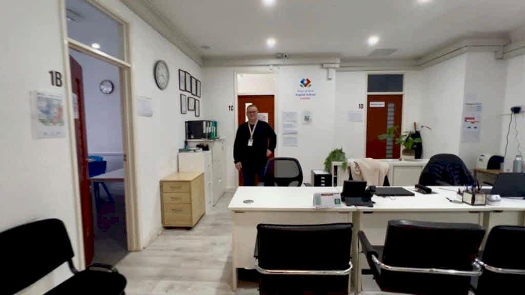Reception office with desks and a staff member at Rose of York English School