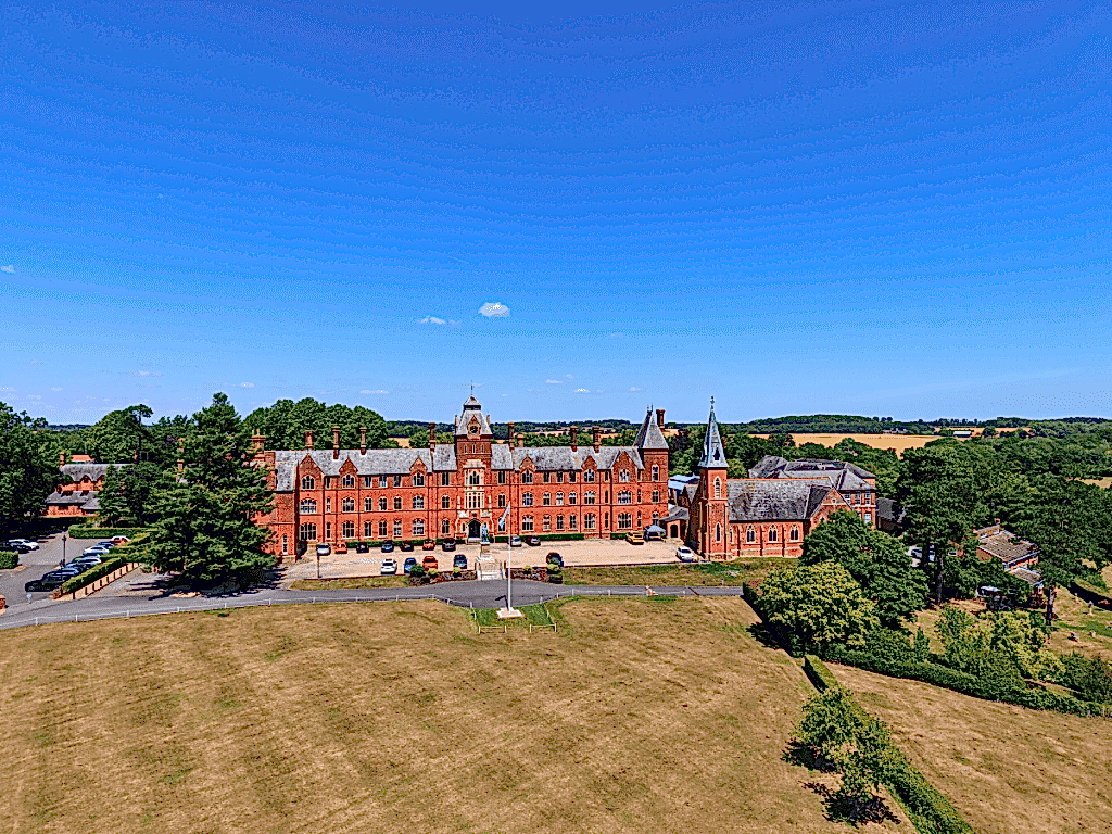 Red-brick main building of ILH Framlingham Summer School seen from the air
