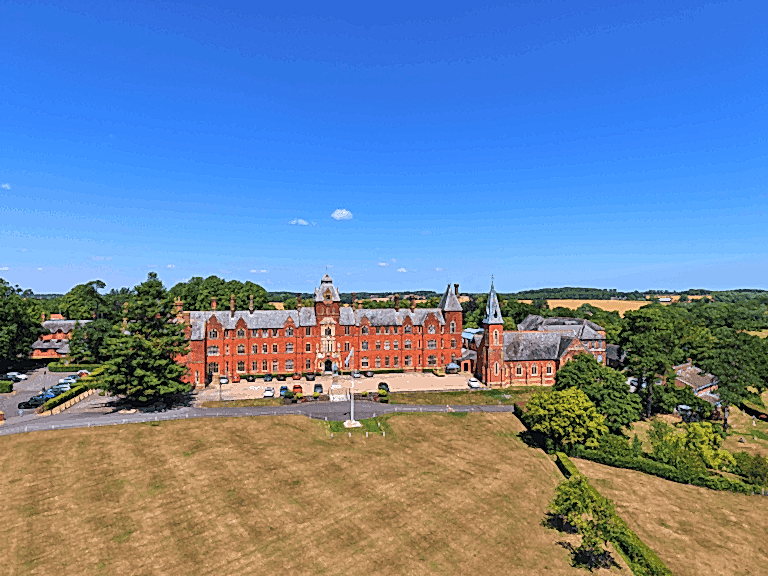 Red-brick main building of ILH Framlingham Summer School seen from the air