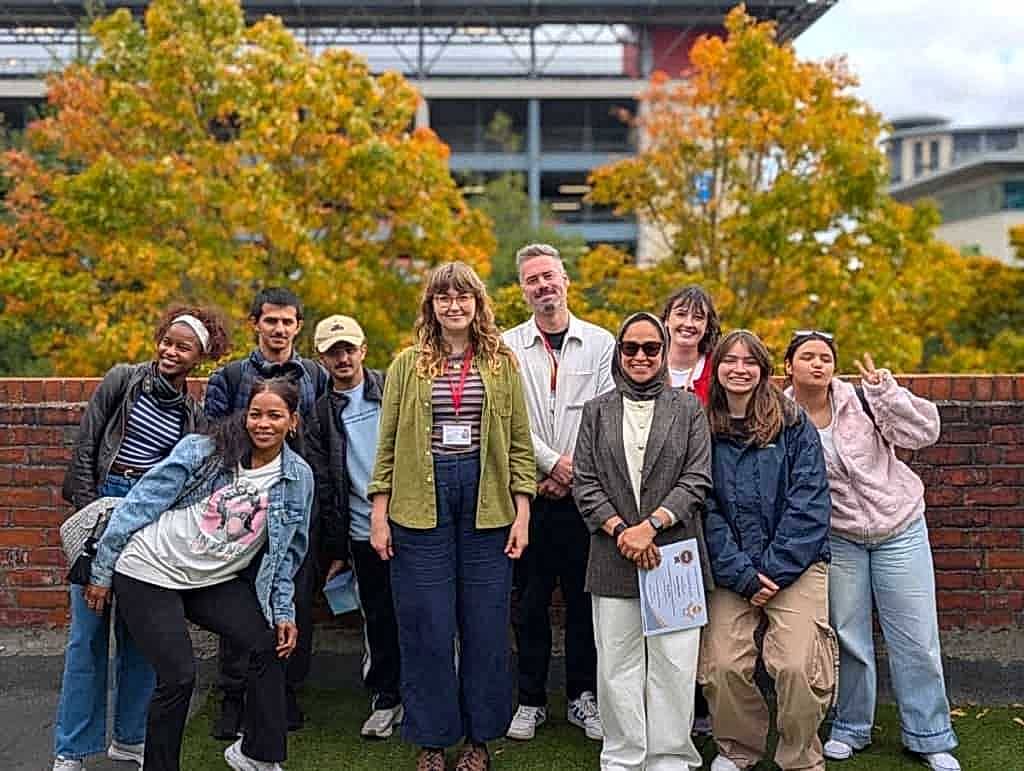 Students and staff gathered outdoors for a graduation at NIS Newcastle