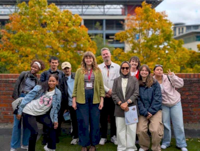 Students and staff gathered outdoors for a graduation at NIS Newcastle