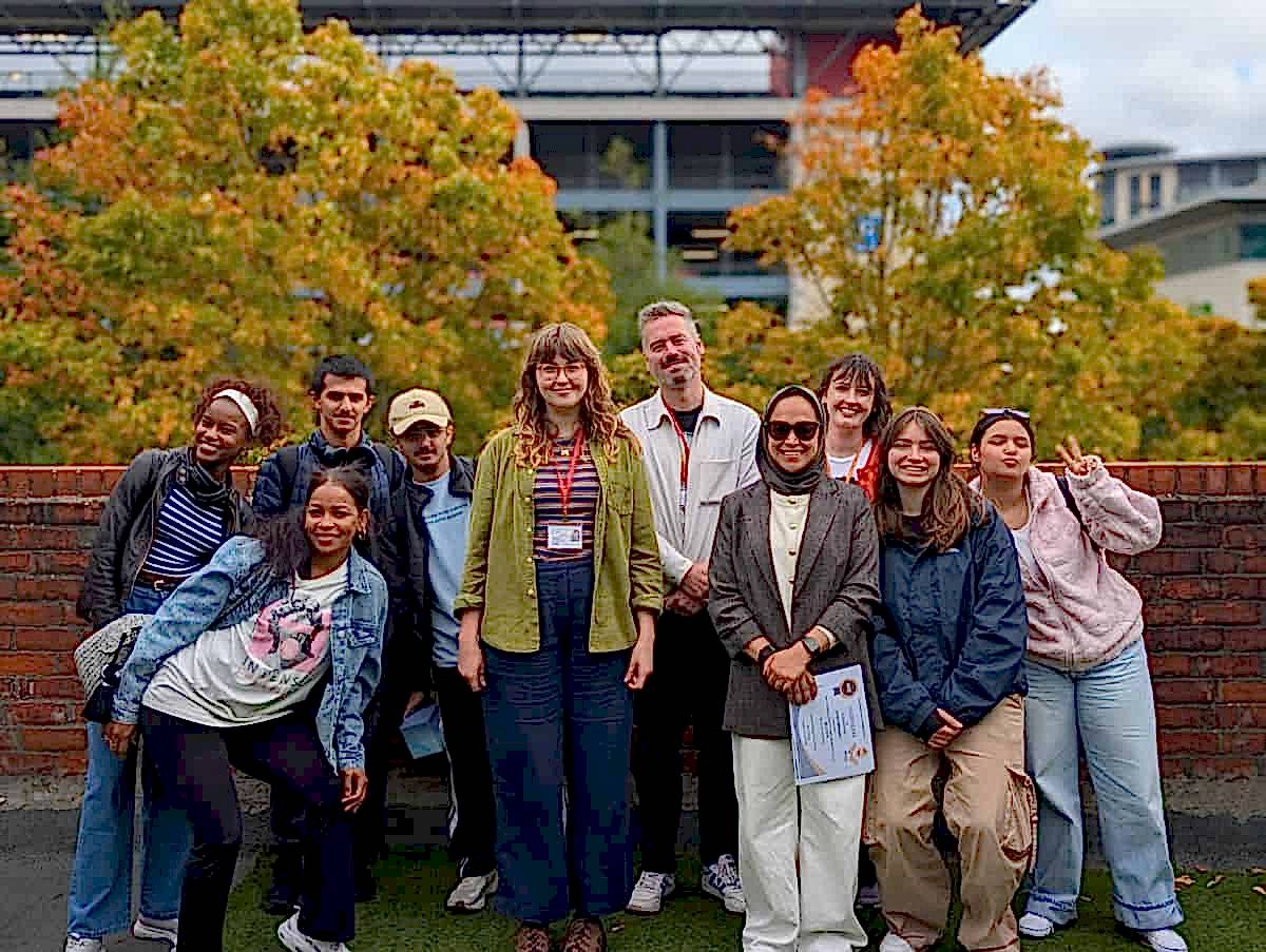 Students and staff gathered outdoors for a graduation at NIS Newcastle