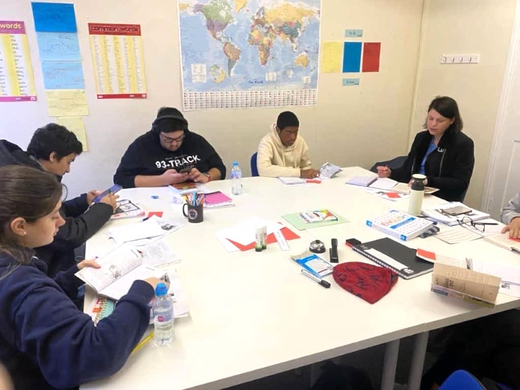 Students working with notes and books around a table at Sheffield Language Centre