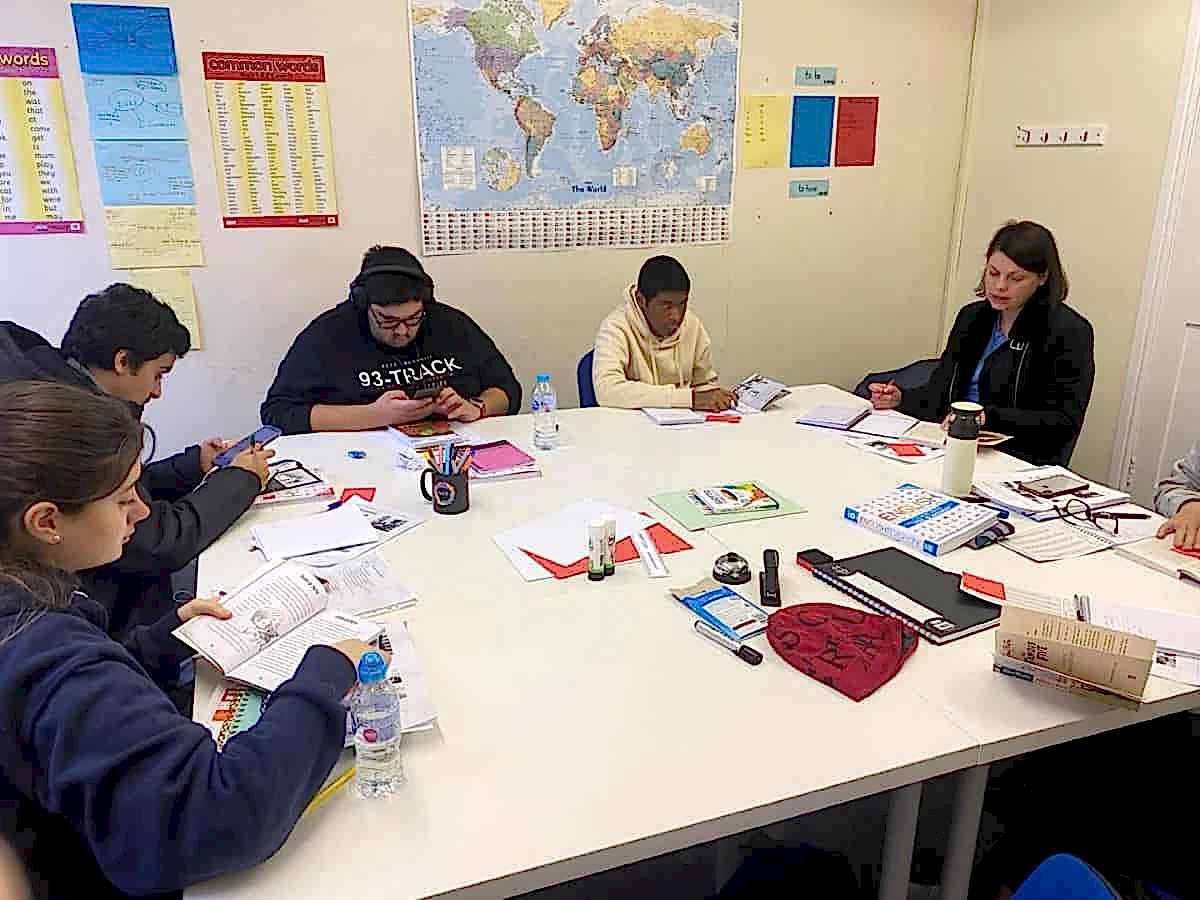 Students working with notes and books around a table at Sheffield Language Centre