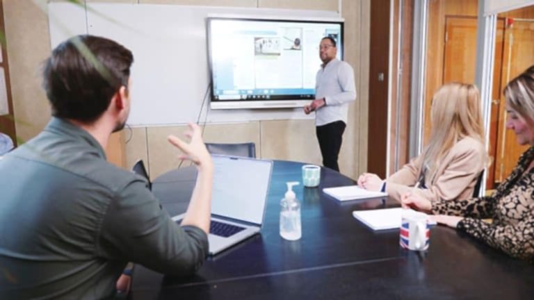 Adult student talking with a teacher in a small class at the Anglo-Continental Executive Centre