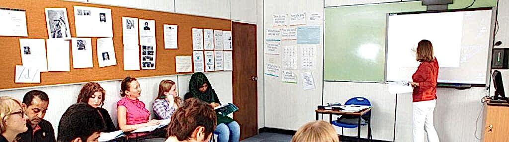 Teacher at the whiteboard with students taking notes at Anglo-Continental