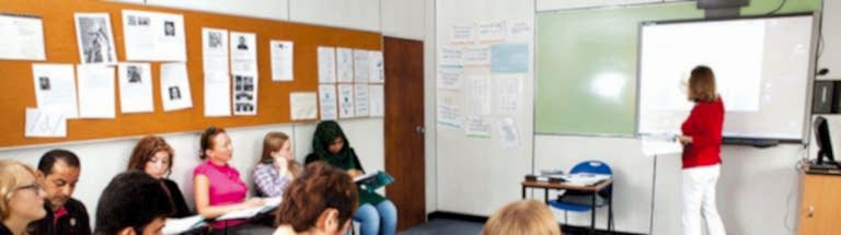 Teacher at the whiteboard with students taking notes at Anglo-Continental