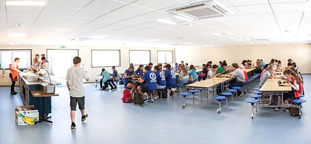 Students eating at long tables in the pavilion at Anglo-Continental Bournemouth