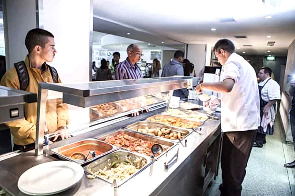 Students choosing hot food at the servery at Anglo-Continental Bournemouth