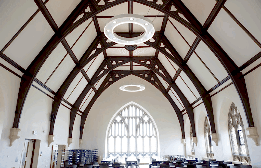 Dining hall with a vaulted timber roof at the British Learning Academy Bristol campus