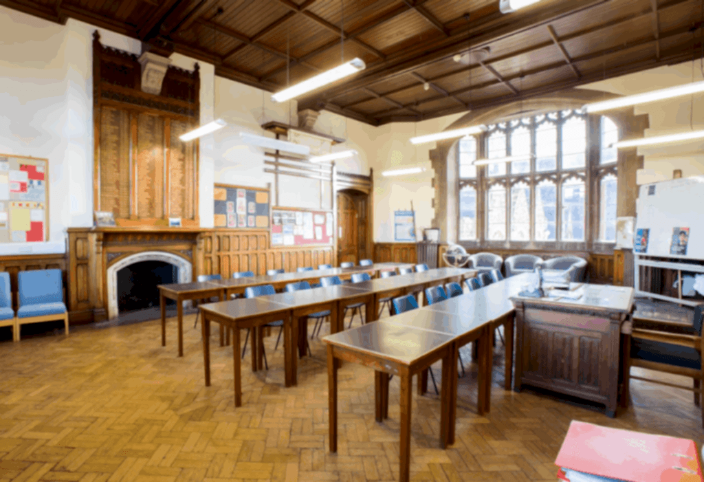 Wood-panelled classroom with long tables at the British Learning Academy Bristol campus