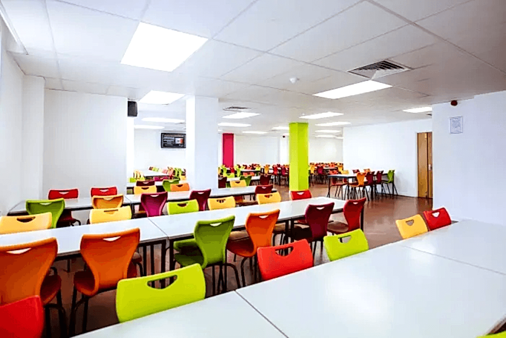 Café with bright coloured chairs in Rees Hall, University of Portsmouth