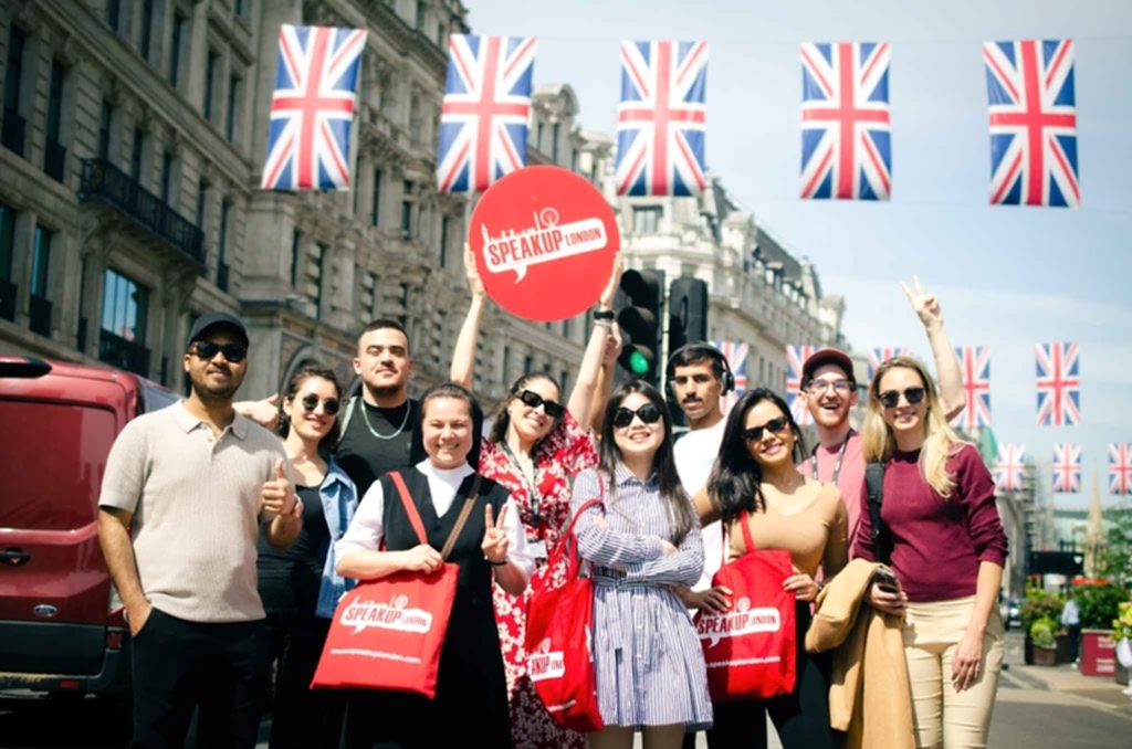 Speak Up London students under Union Jack bunting on a London street
