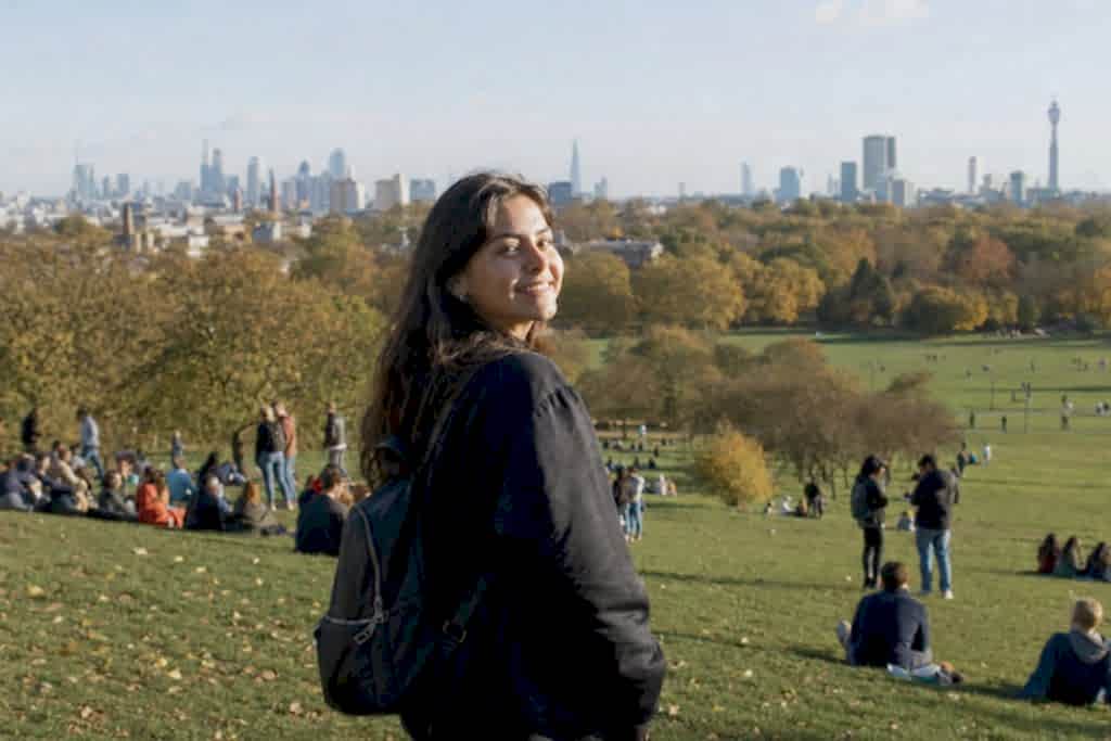 Student looking out over the London skyline from Primrose Hill