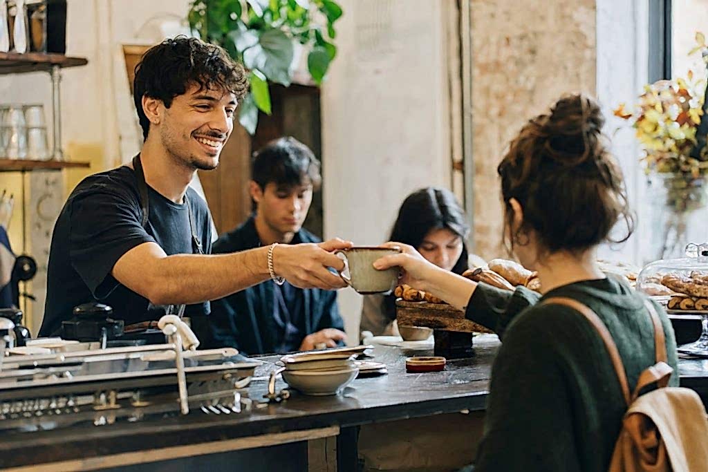 Student working as a barista in a London cafe