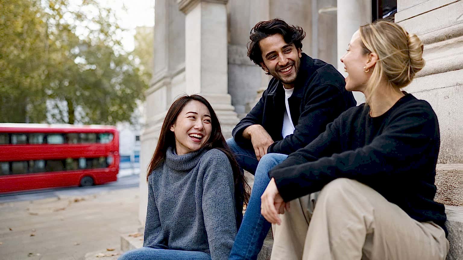 International students chatting on the steps of a London building