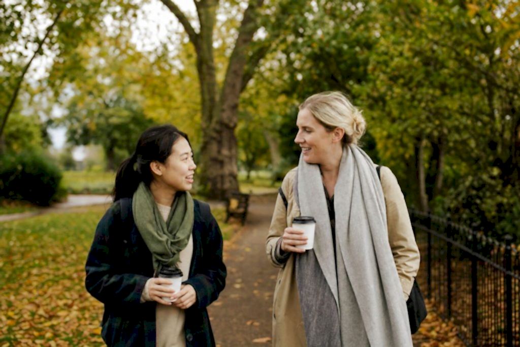 A student and her host tutor walking in a London park